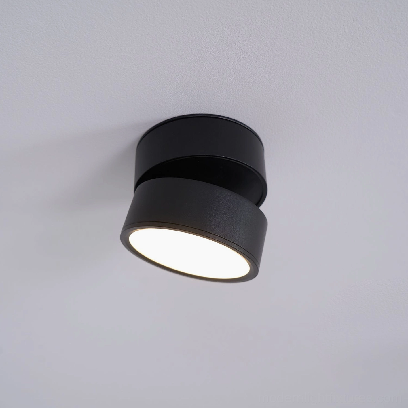 Surface-mounted rotatable spot light demonstrating seamless ceiling integration in modern interior design