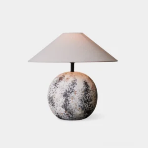 Surya ceramic textured table lamp front view - spherical mottled base with conical beige fabric shade isolated on white background