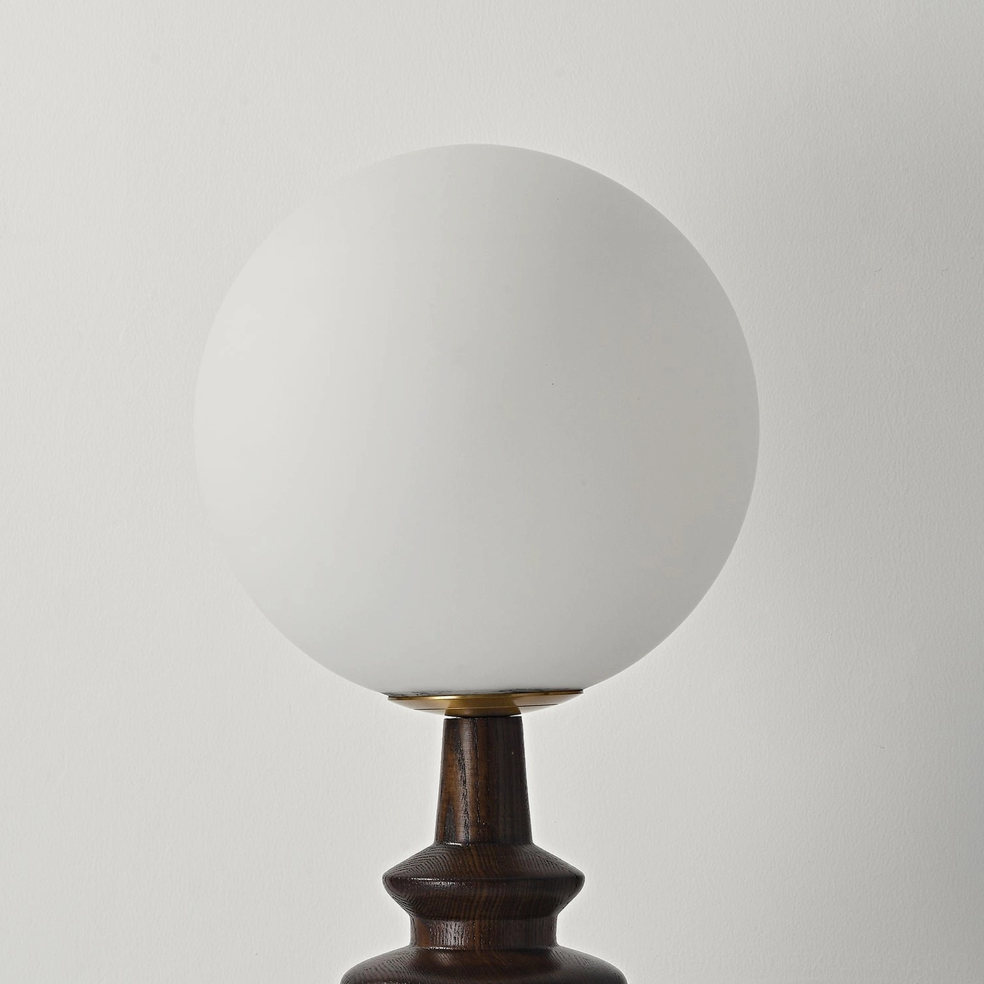 Sveta globe table lamp side angle view - sculptural wood base design with ambient illumination