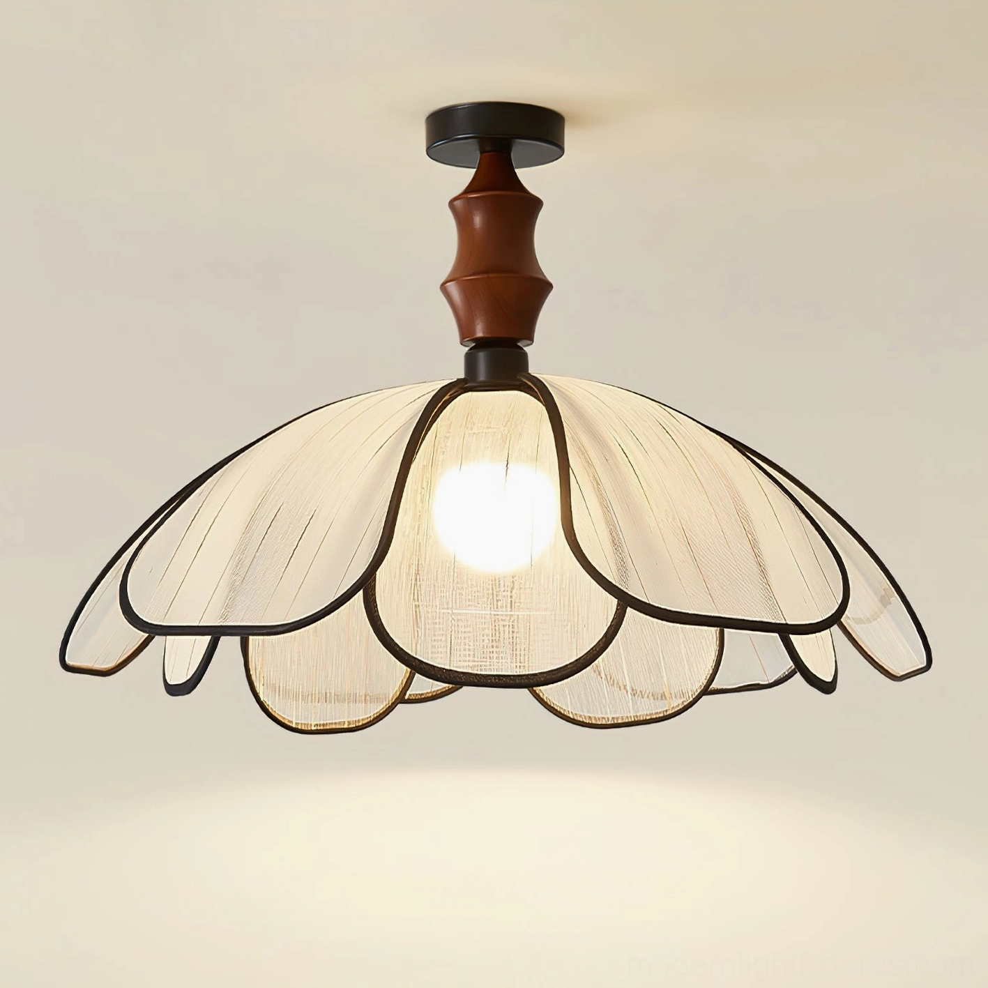 Illuminated petal ceiling light fixture with beige shade and black trim, three-quarter angle studio view