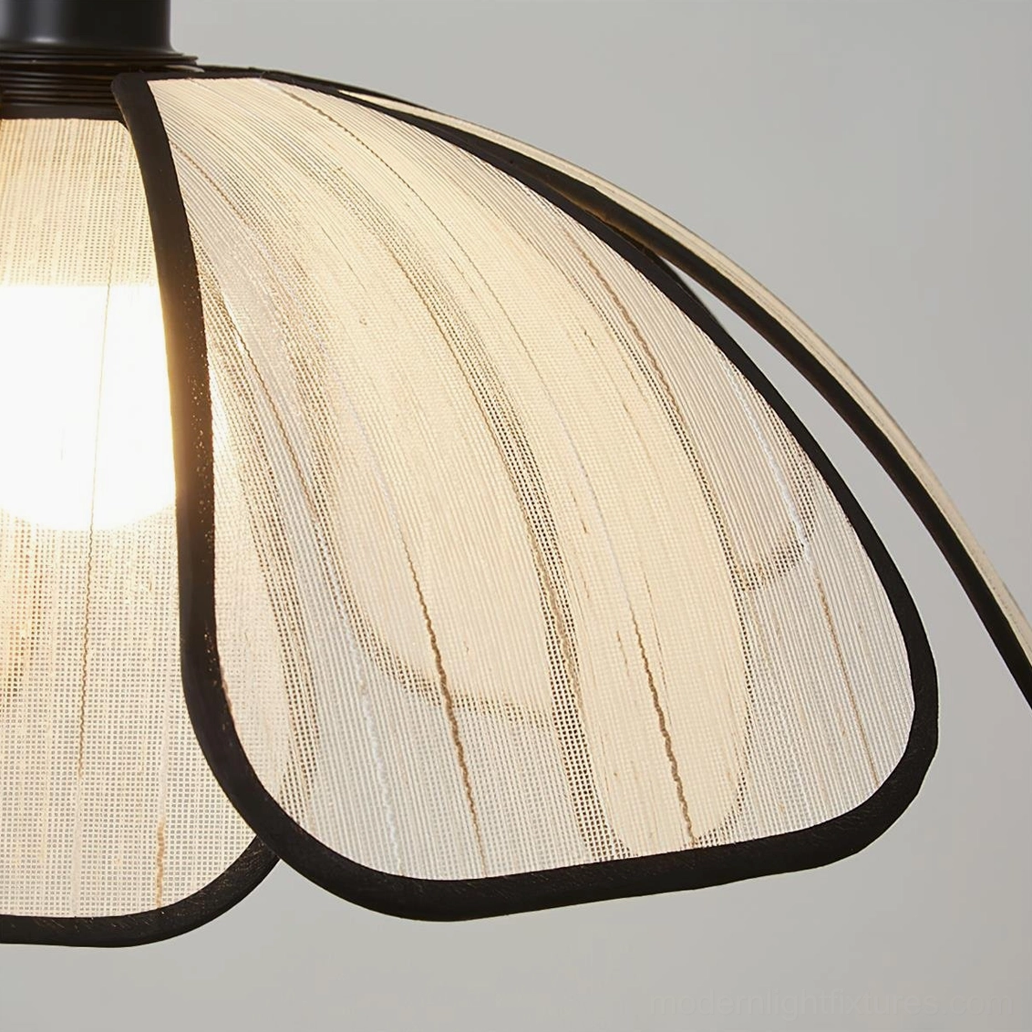 Close-up macro detail of Swanpetal ceiling light shade, ribbed texture and black fabric edging, visible bulb
