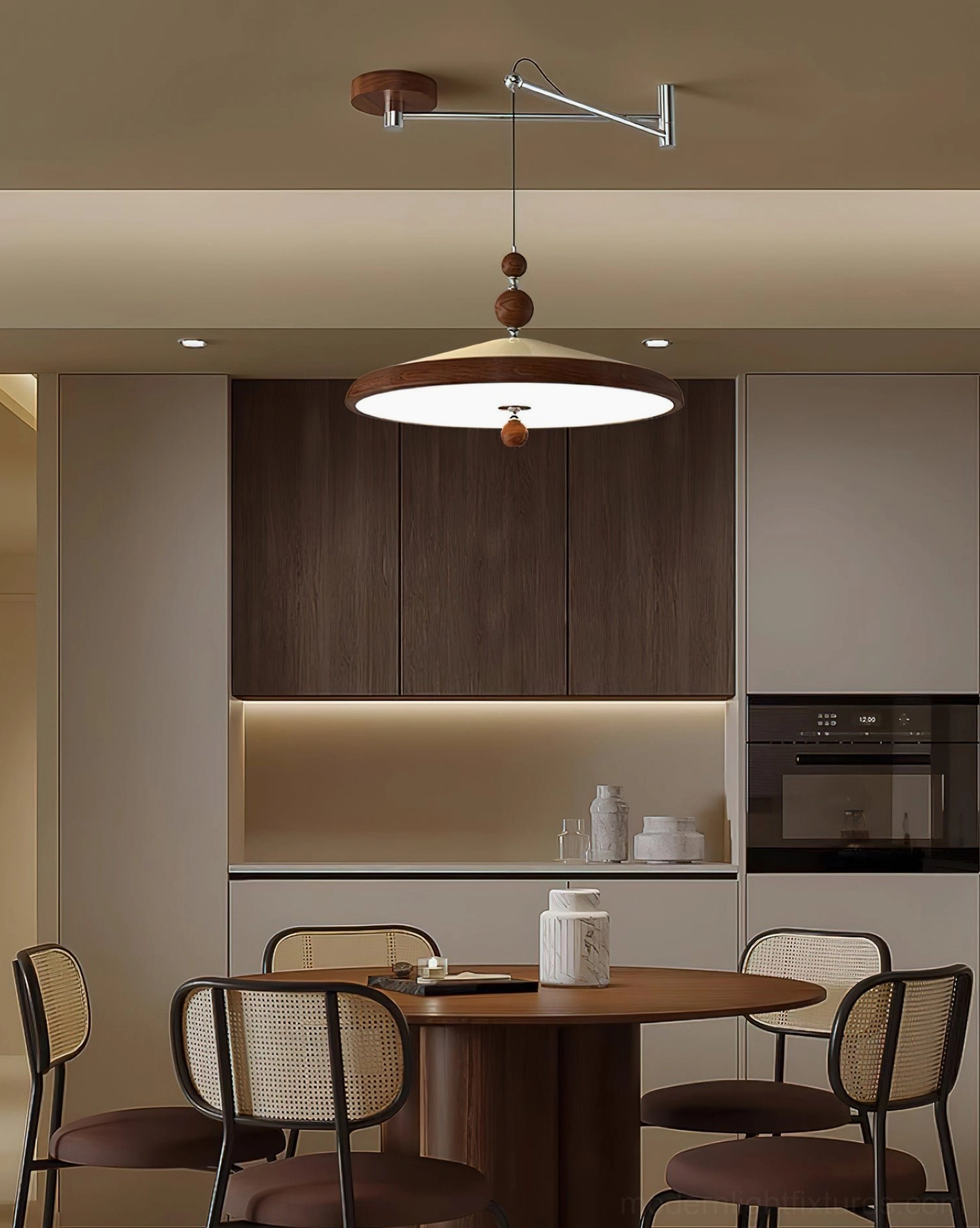Modern swing arm pendant light fixture suspended above round wooden dining table in contemporary kitchen dining area