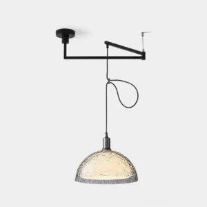Modern adjustable swing arm pendant light with black metal bracket and clear hammered glass shade - studio front view