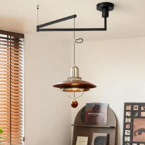 Adjustable swing arm pendant light installed in residential home corner, showing black metal boom and brown metal shade