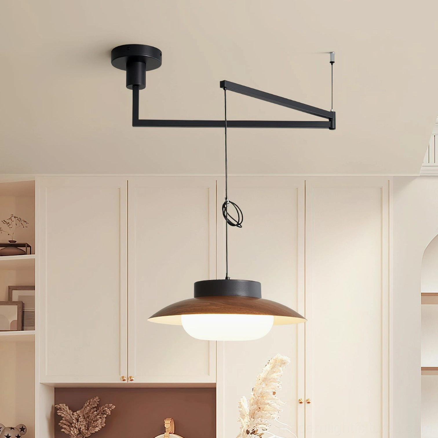 Adjustable swing arm pendant lamp in kitchen dining nook, warm neutral interior setting with black frame