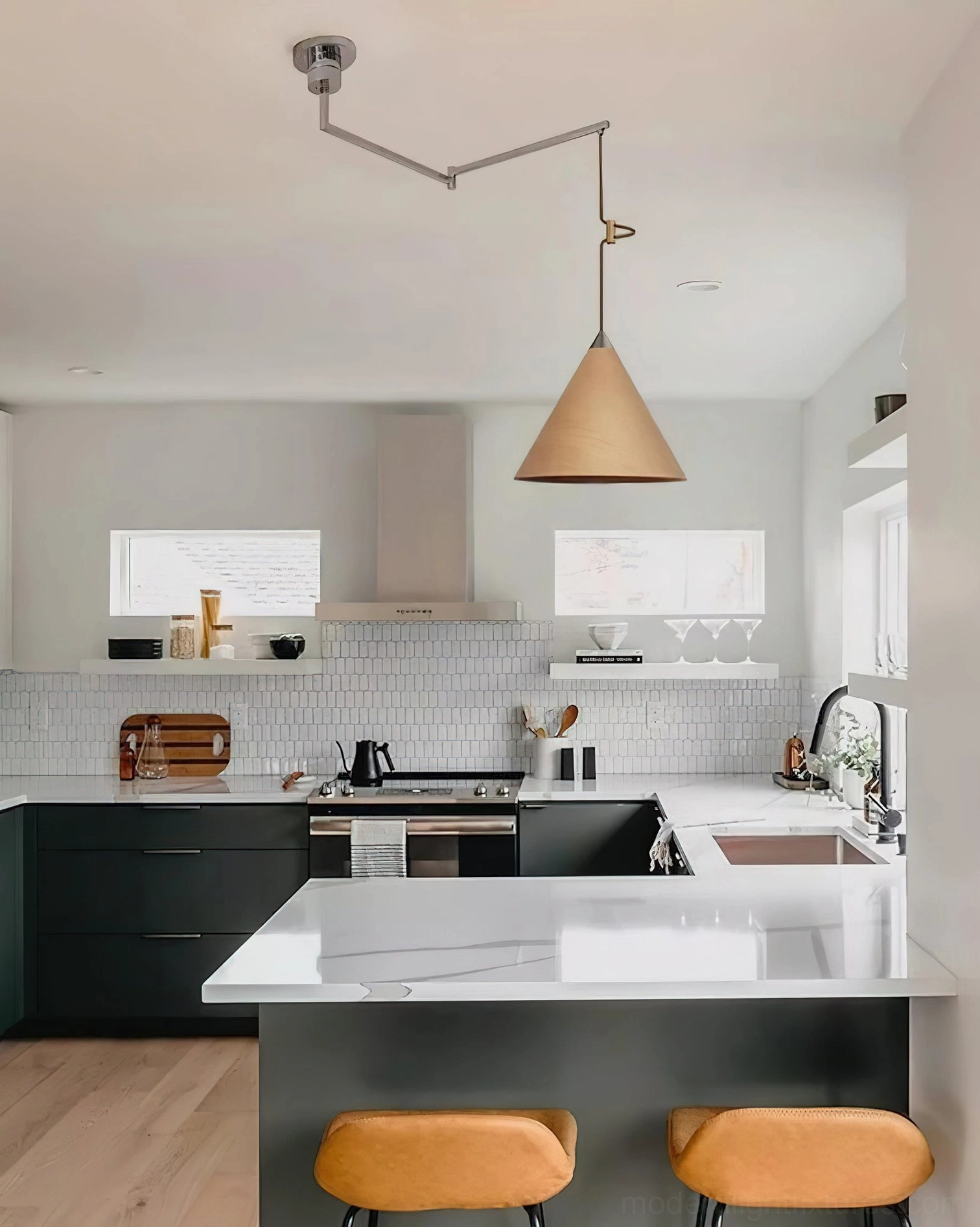 Adjustable swing arm pendant light installed above modern kitchen island with dining area