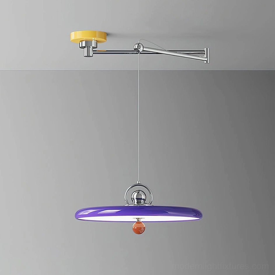 Side view of adjustable swing arm pendant light with purple glossy disc shade and yellow ceiling mount in studio setting
