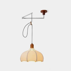 Revi adjustable swing arm pendant light with scalloped fabric shade and walnut wood frame, front studio view