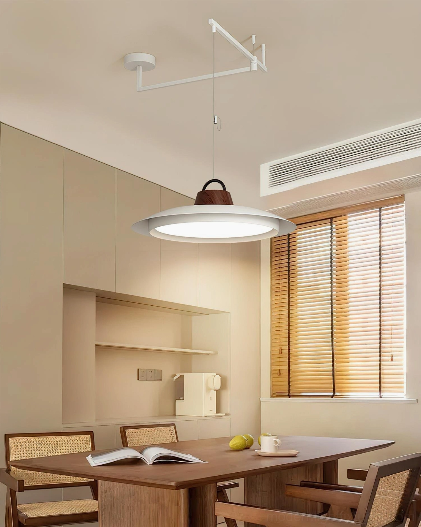 Contemporary swing arm pendant lamp in minimalist white dining room with warm ambient lighting