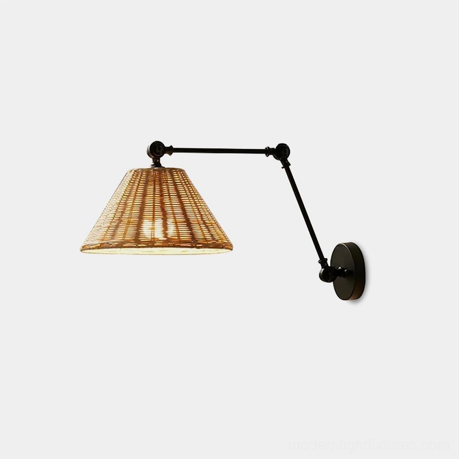 Swing arm wall sconce with woven rattan shade and matte black metal framework - front view