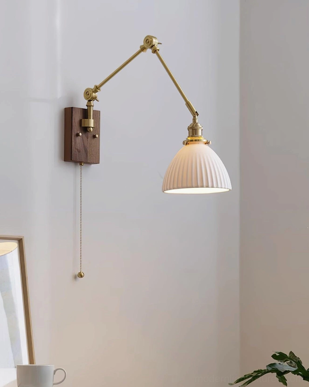Swing arm wall sconce bathroom installation, damp-rated fixture beside mirror and vanity