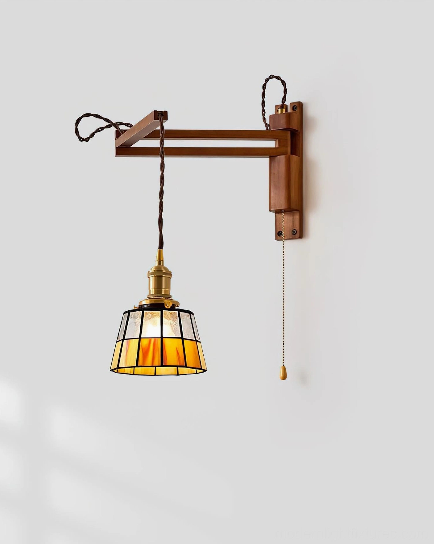 Vintage-style wall-mounted swing arm sconce with wooden walnut frame positioned in contemporary living room interior setting, accent lighting beside artwork