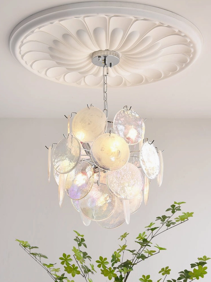 Detailed close-up of swirled iridescent glass discs on modern pendant light fixture