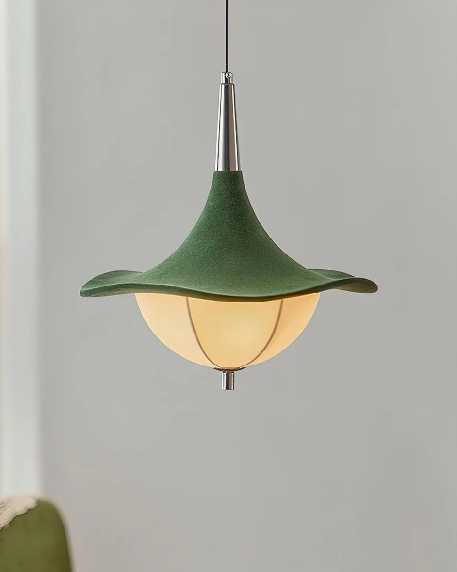 Close-up of Sylva Drift pendant light with lit frosted glass shade and polished silver hanging rod