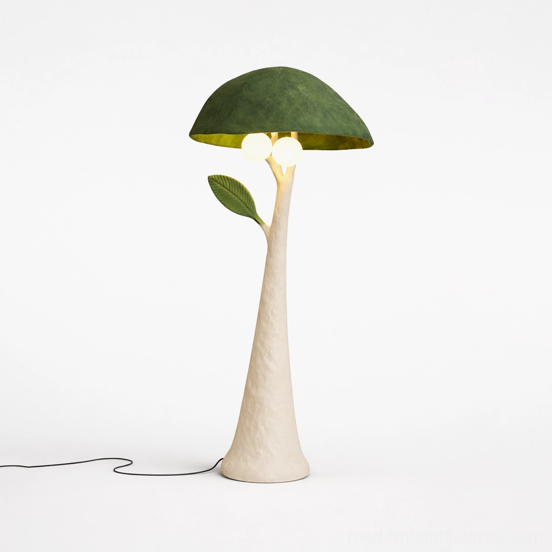 Sylvara floor lamp with green velvet shade and beige textured resin stem with leaf ornament, product showcase on white background