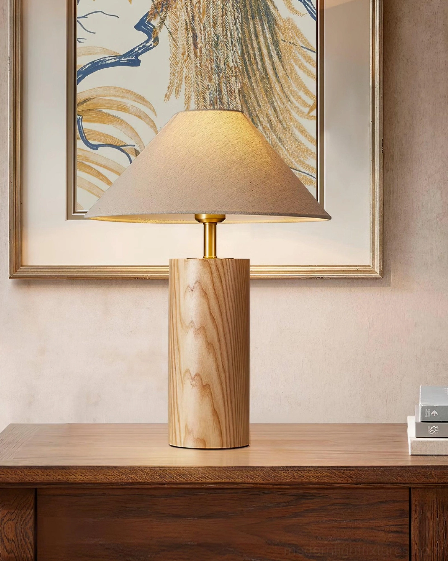Contemporary wooden lamp on dark wood dresser in minimalist bedroom with framed wall art