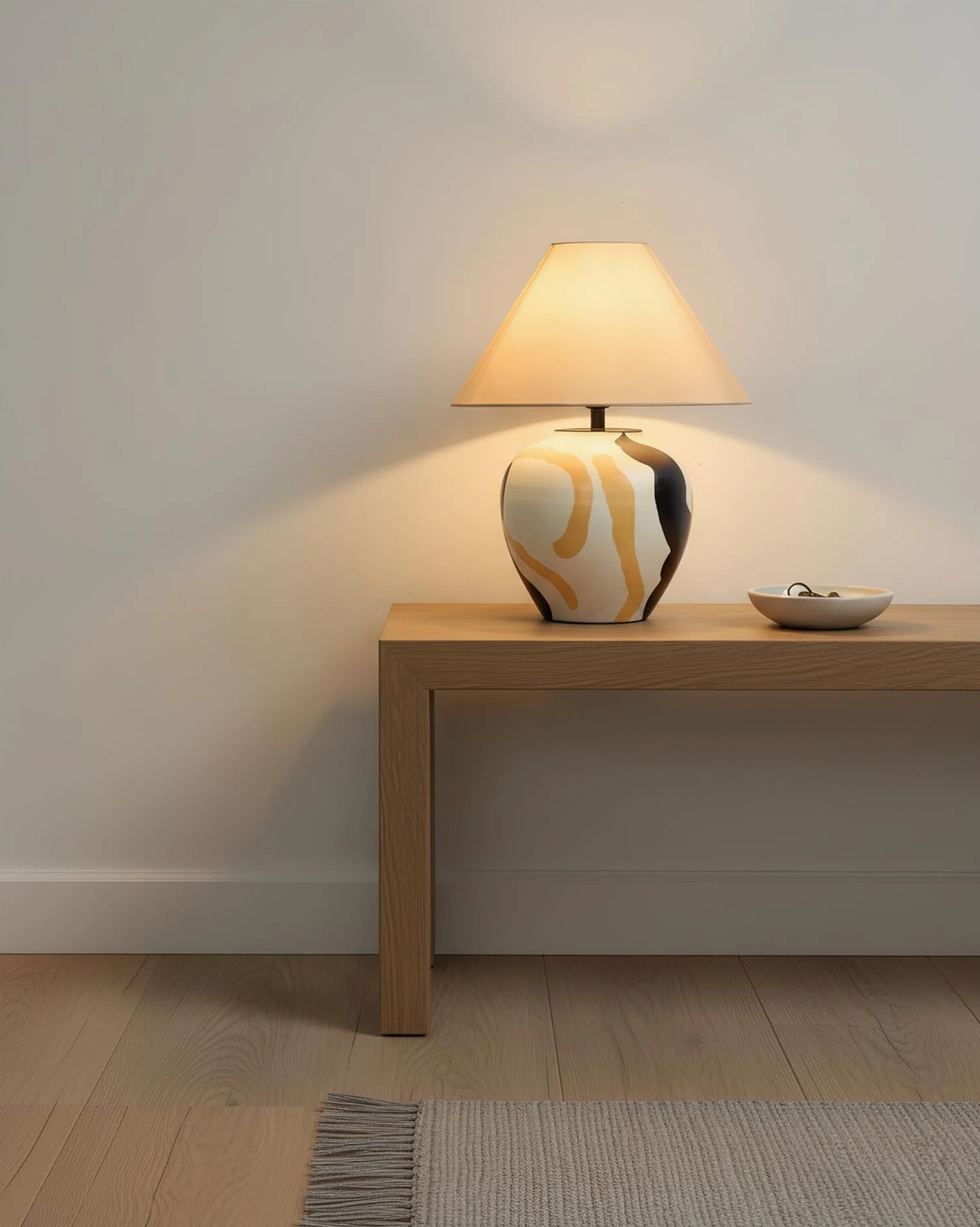 Desert Swirl ceramic table lamp on minimalist entryway console table with small decorative bowl and modern boho styling