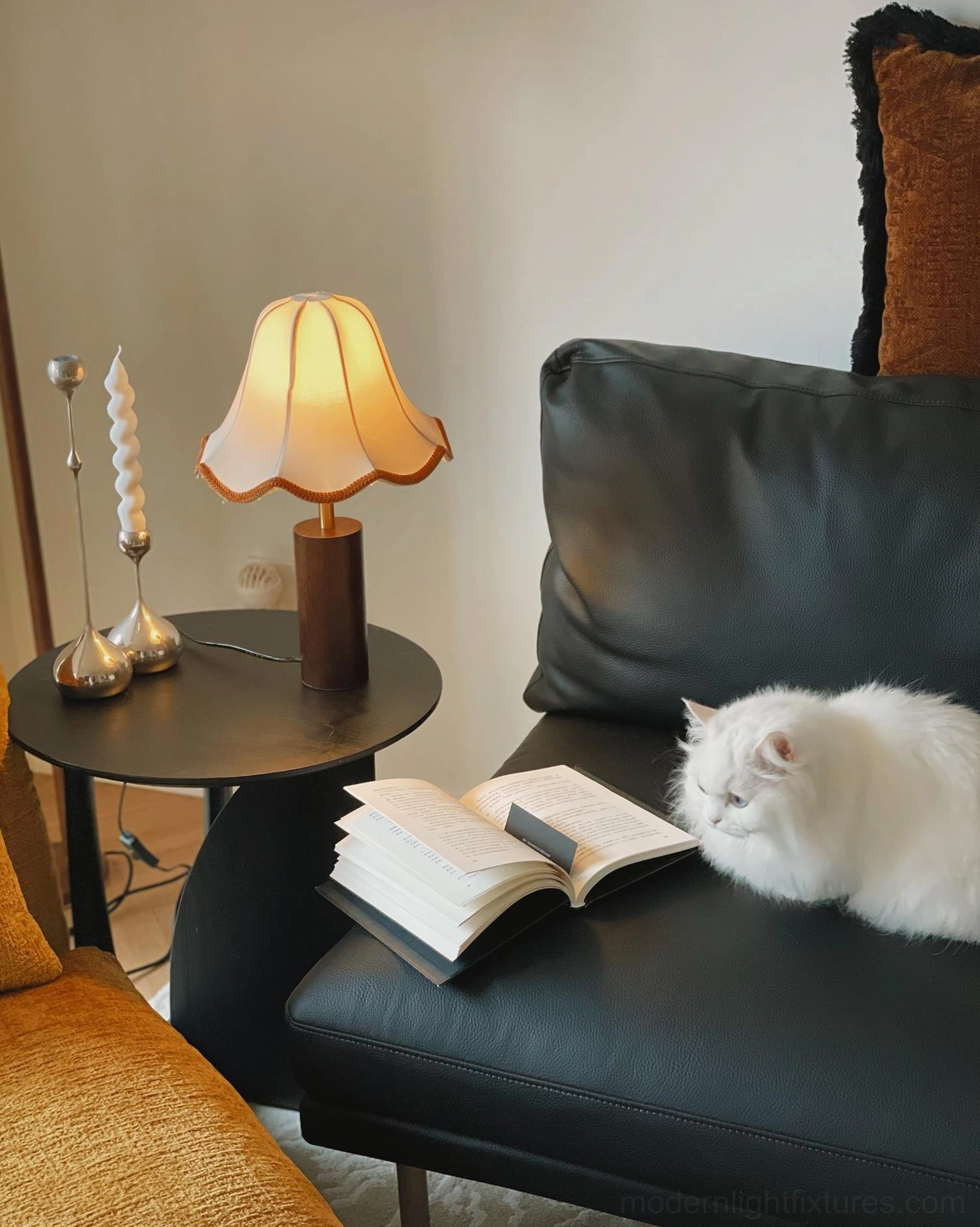 Table lamp creating cozy glowing ambiance on bedroom nightstand with soft scalloped shade light