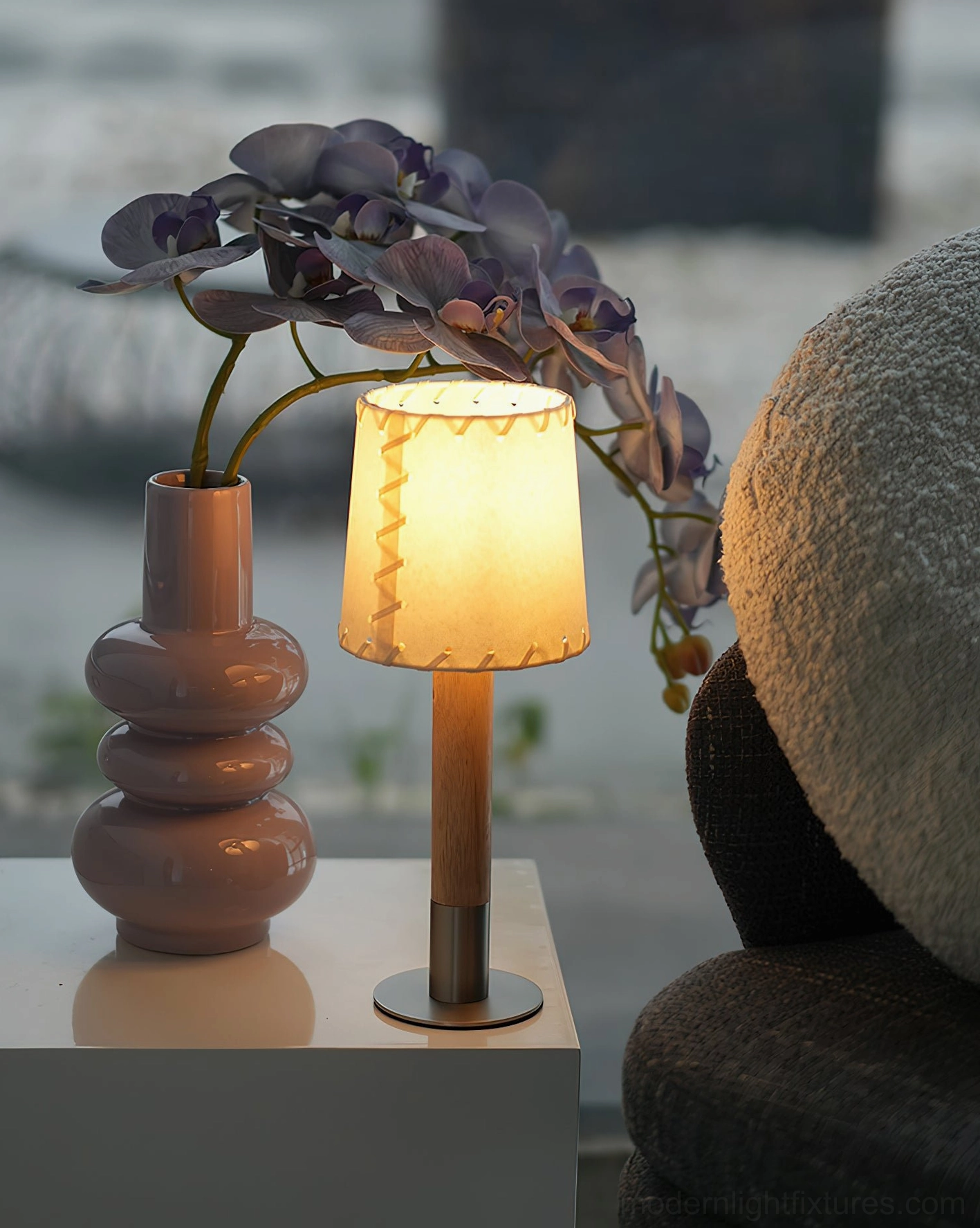 Handcrafted minimalist table lamp with wood stem and stitched fabric shade detail view