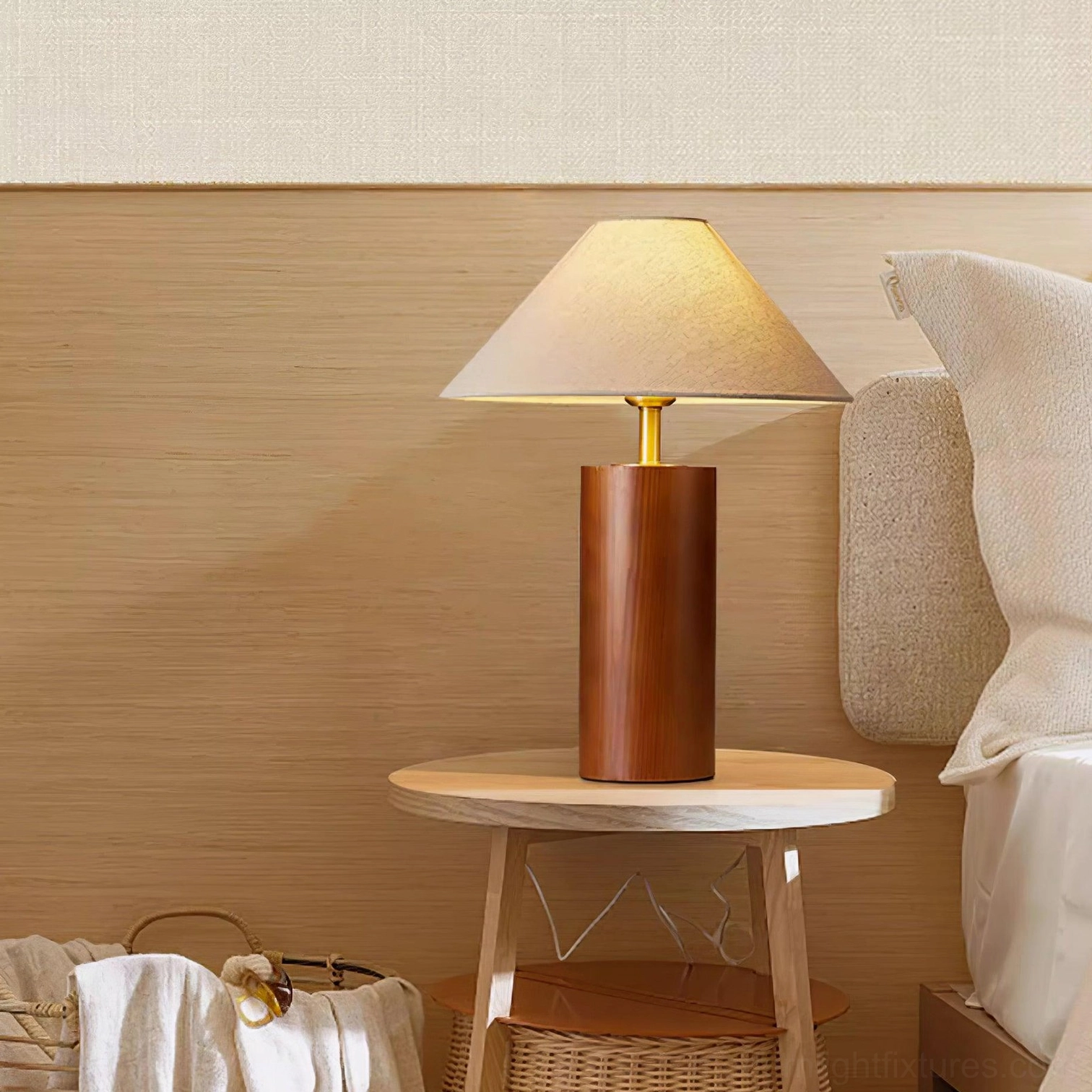 Table lamp with textured fabric shade diffusing soft warm light in residential bedroom