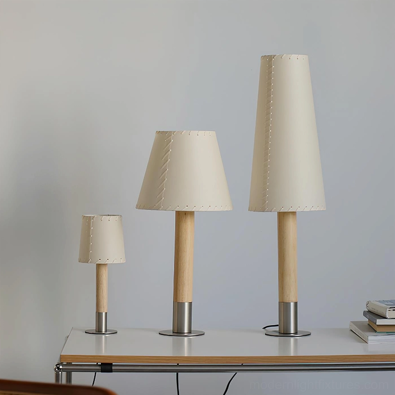 Three sizes of modern minimalist table lamps displaying small medium and large stitched fabric shade designs