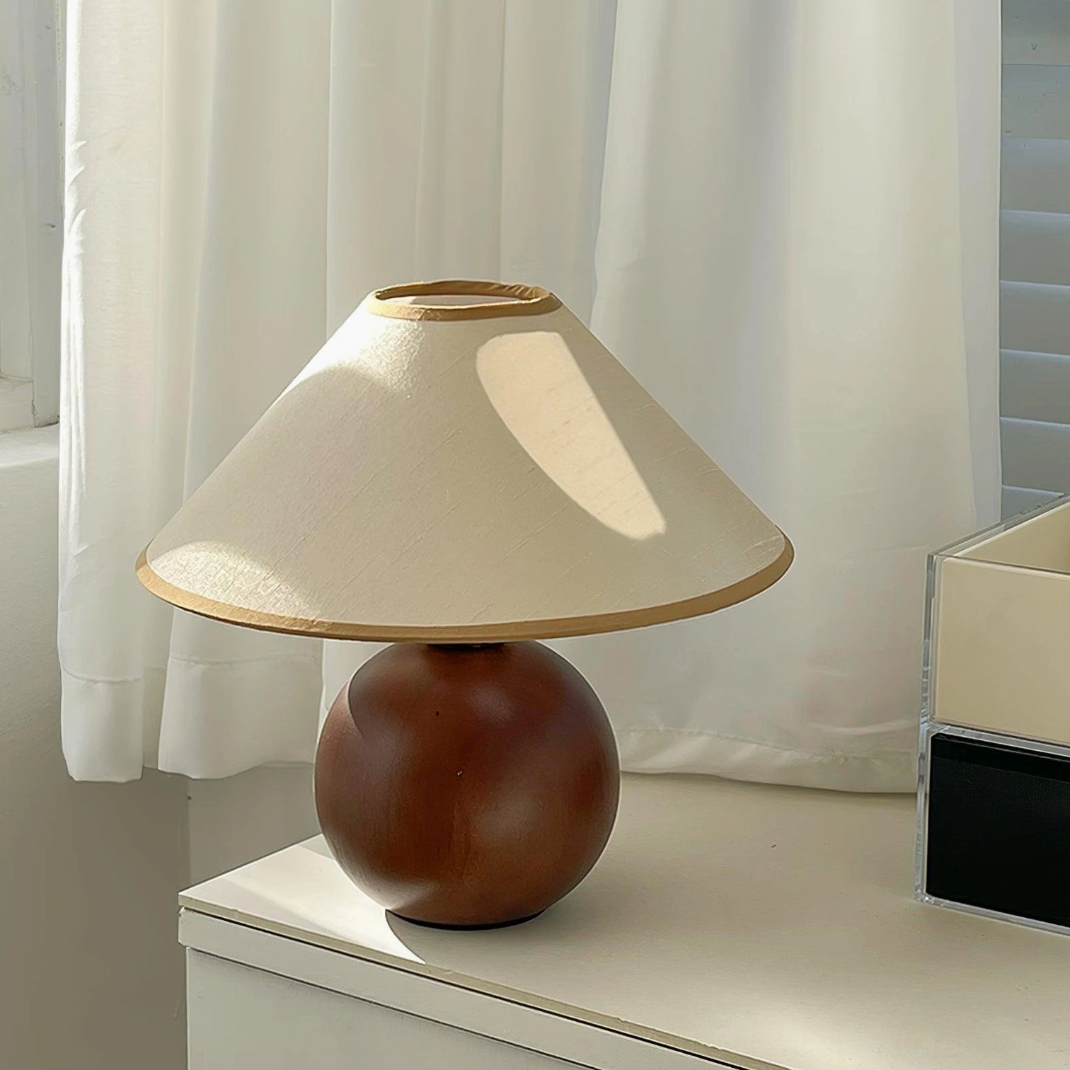 Table lamp with walnut base and fabric shade, styled in home interior design scene