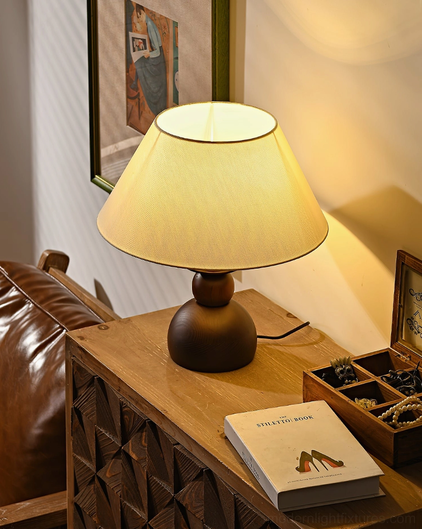 Walnut wood table lamp with fabric shade detail showing warm light diffusion and base construction