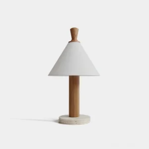 Takumi minimalist table lamp with white linen shade, fluted light wood pole, and travertine stone base in studio setting