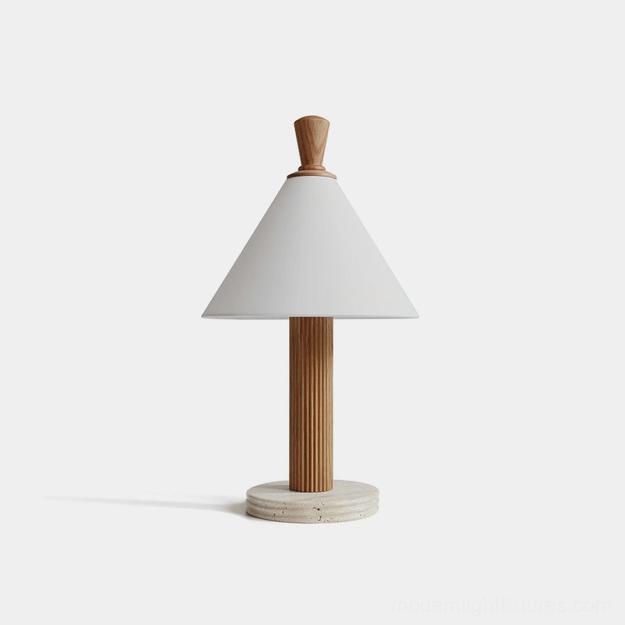 Takumi minimalist table lamp with white linen shade, fluted light wood pole, and travertine stone base in studio setting