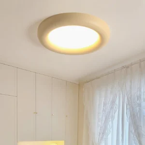 Talena cream colored modern ceiling light installed in minimalist bedroom closet with warm ambient glow