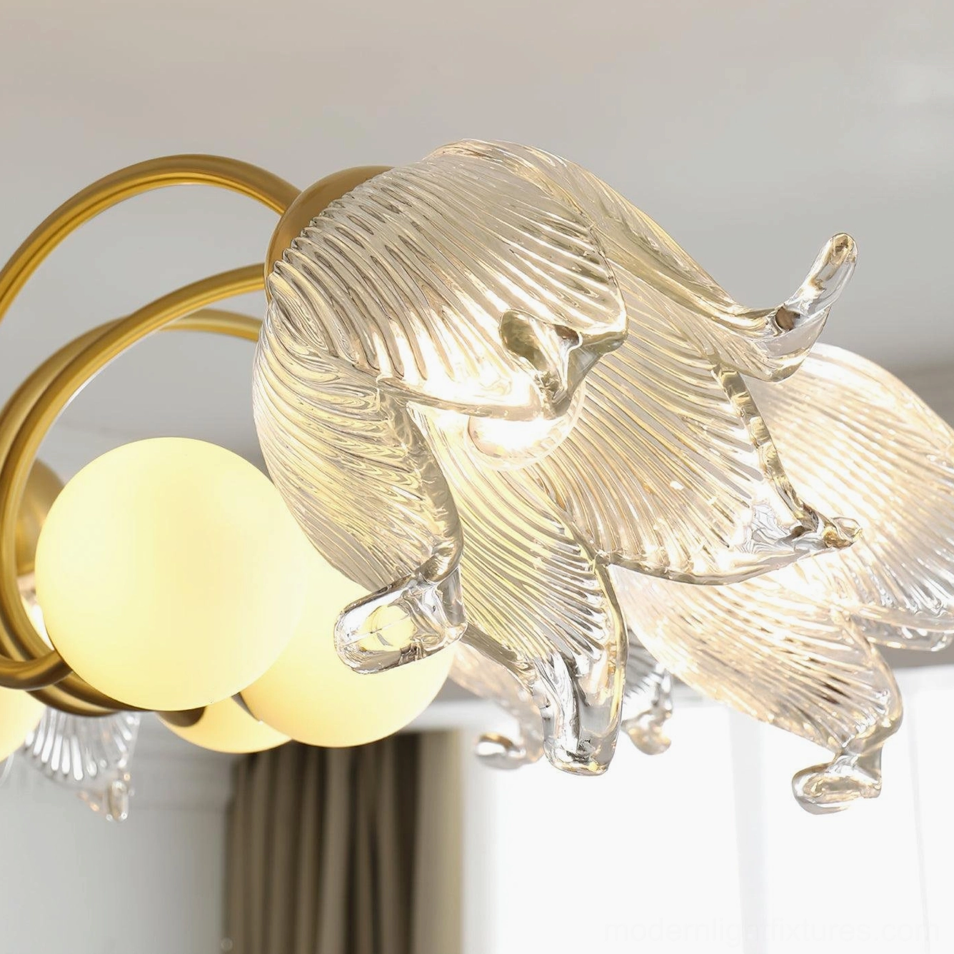 Talia modern chandelier softly illuminated ambient lighting in contemporary minimalist interior