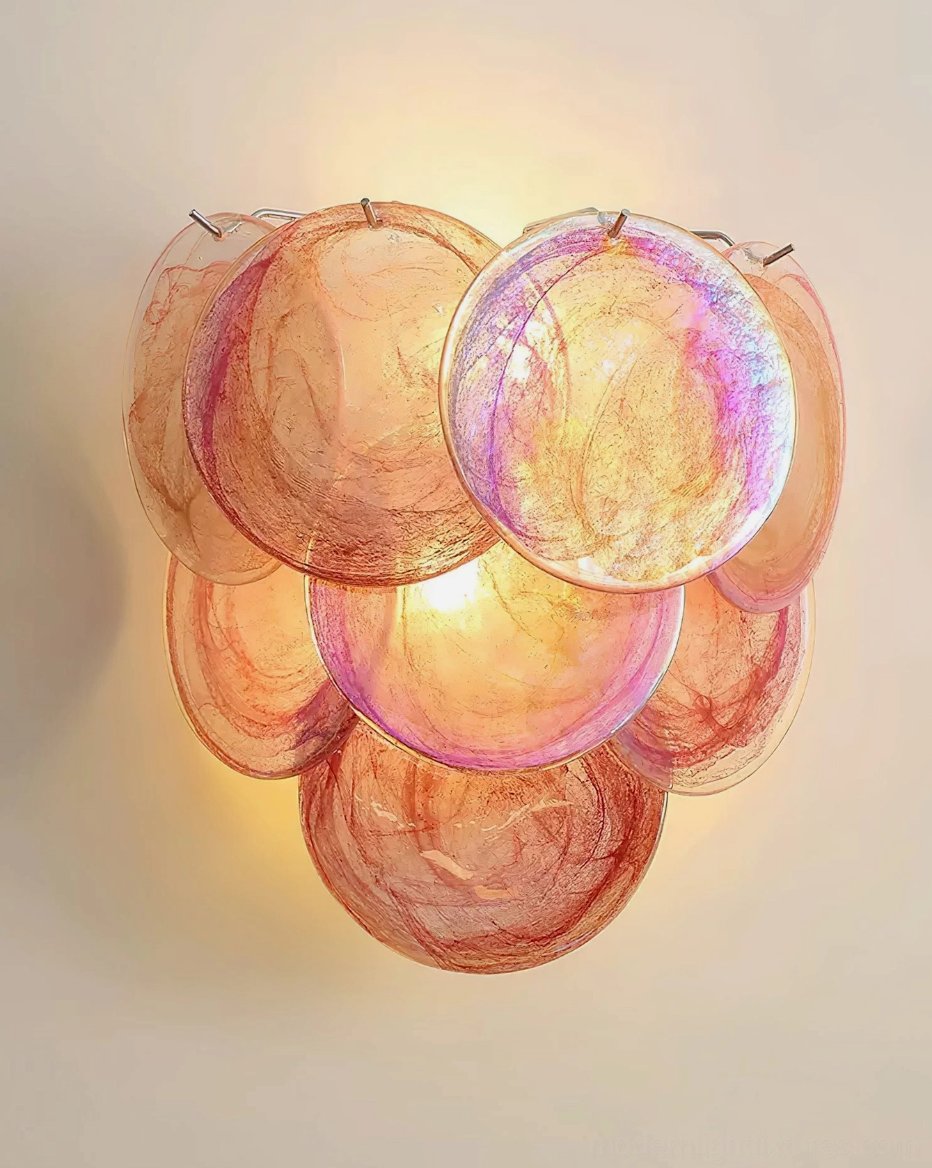 Warm peach-pink iridescent Talia bubble glass wall sconce mounted on accent wall showing close-up of hand-blown glass clusters and artistic glow