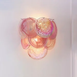 Illuminated Talia hand-blown glass wall sconce with pink iridescent bubble clusters glowing, artistic glass wall lamp showing luminous color swirls