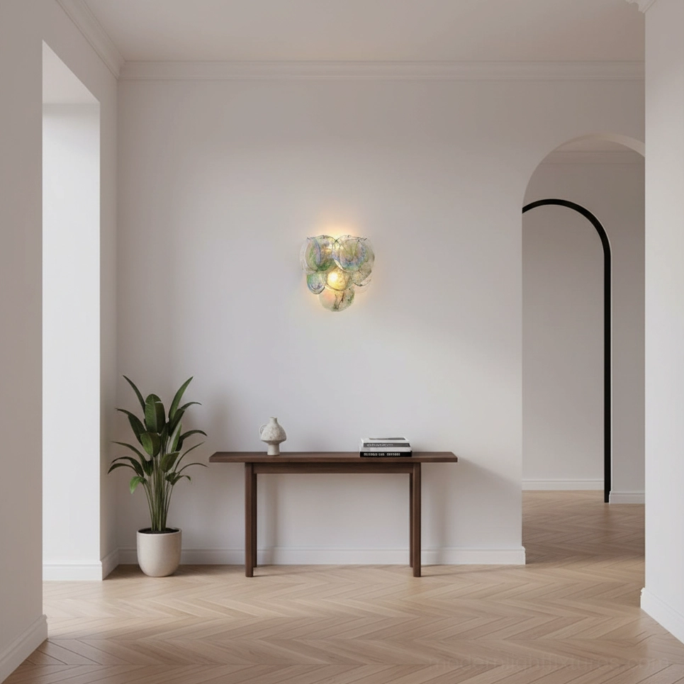 Talia hand-blown glass bubble wall sconce in minimalist entryway hallway above wooden console table with potted plant, contemporary lighting fixture