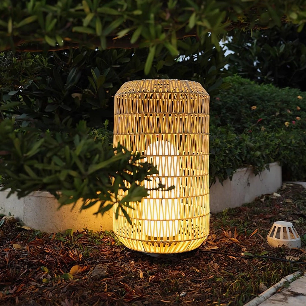 Tall woven rattan outdoor lamp viewed from low angle in residential garden yard setting