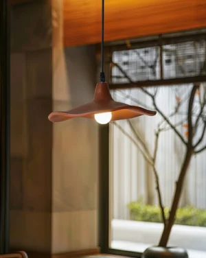 Single Talmera pendant lamp installed in modern residential interior with warm ambient lighting near window