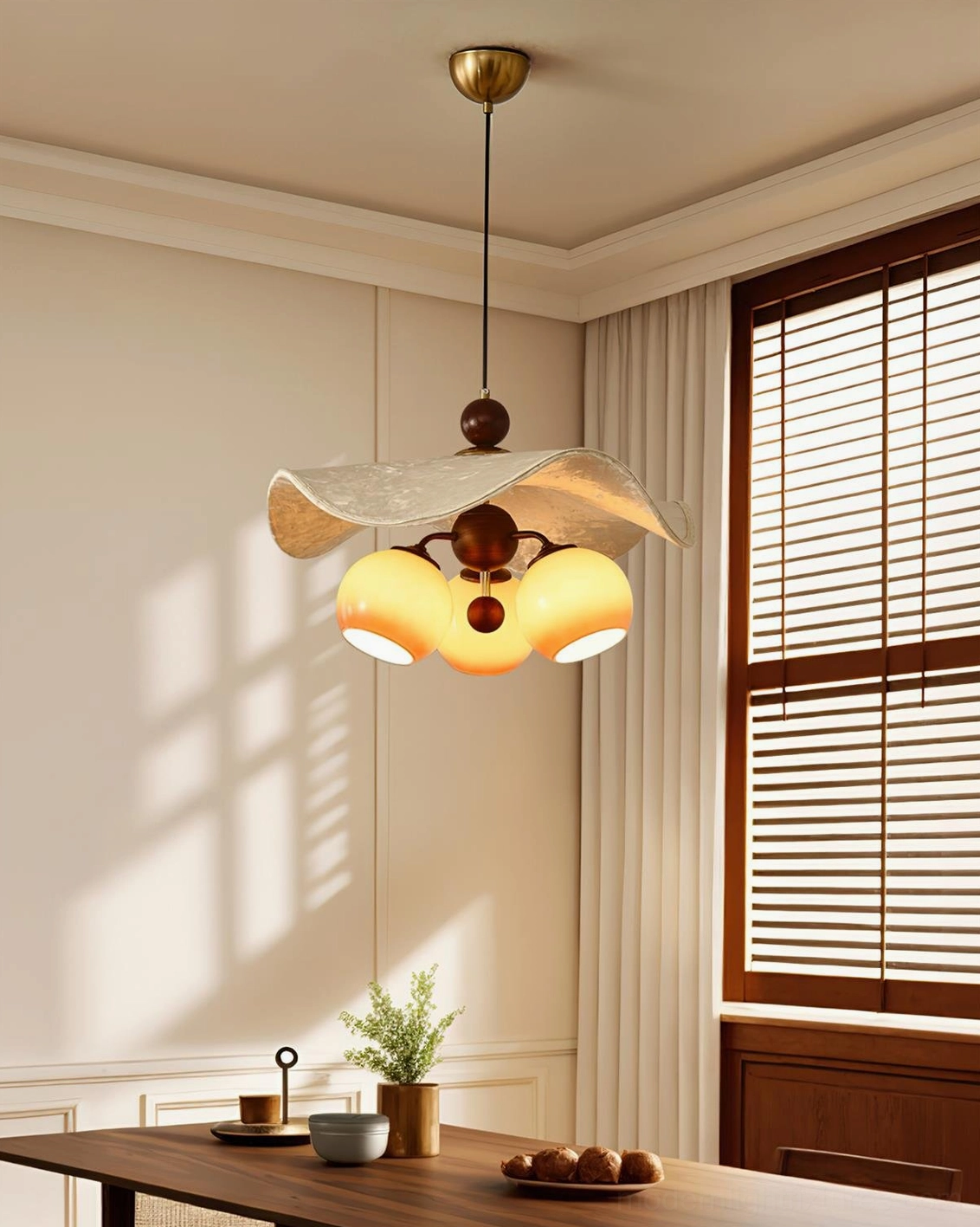 Talvera sculptural pendant light installed above farmhouse dining table with warm ambient glow
