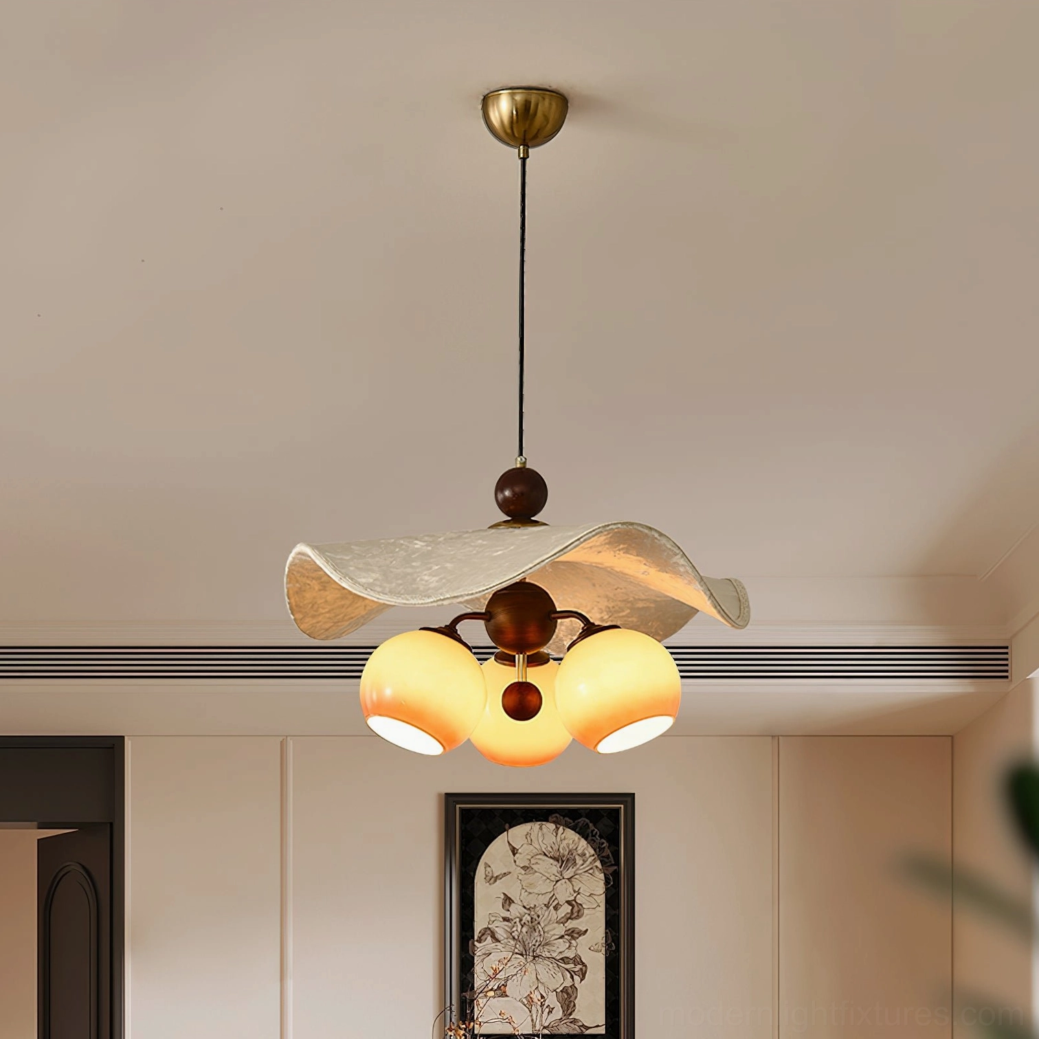 Talvera sculptural pendant light in minimalist living room with brass hardware and warm glow