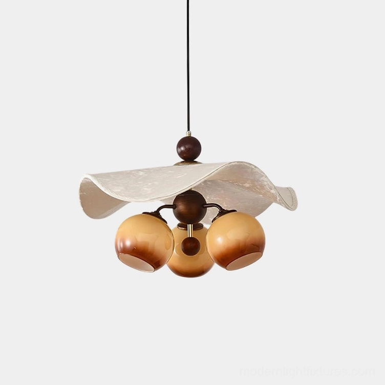 Talvera sculptural pendant light with amber glass bulbs and wavy fabric shade in modern dining room setting