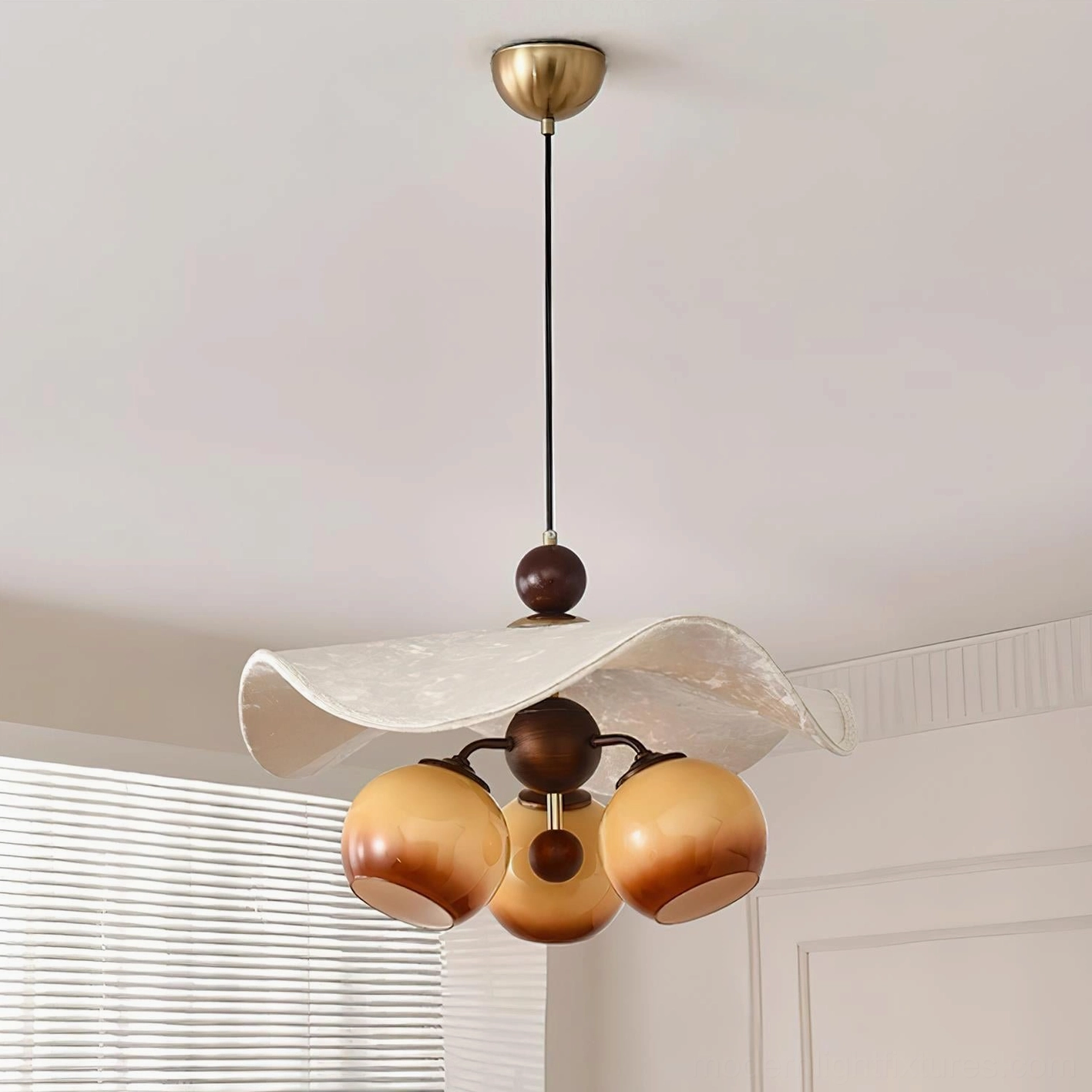 Talvera three-bulb pendant lamp with gradient amber glass spheres and wood accents in contemporary interior