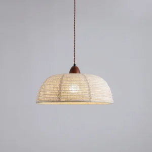 Tanto pendant light showing three-quarter view of twisted fabric suspension cord and textured dome shade, minimalist pendant lighting