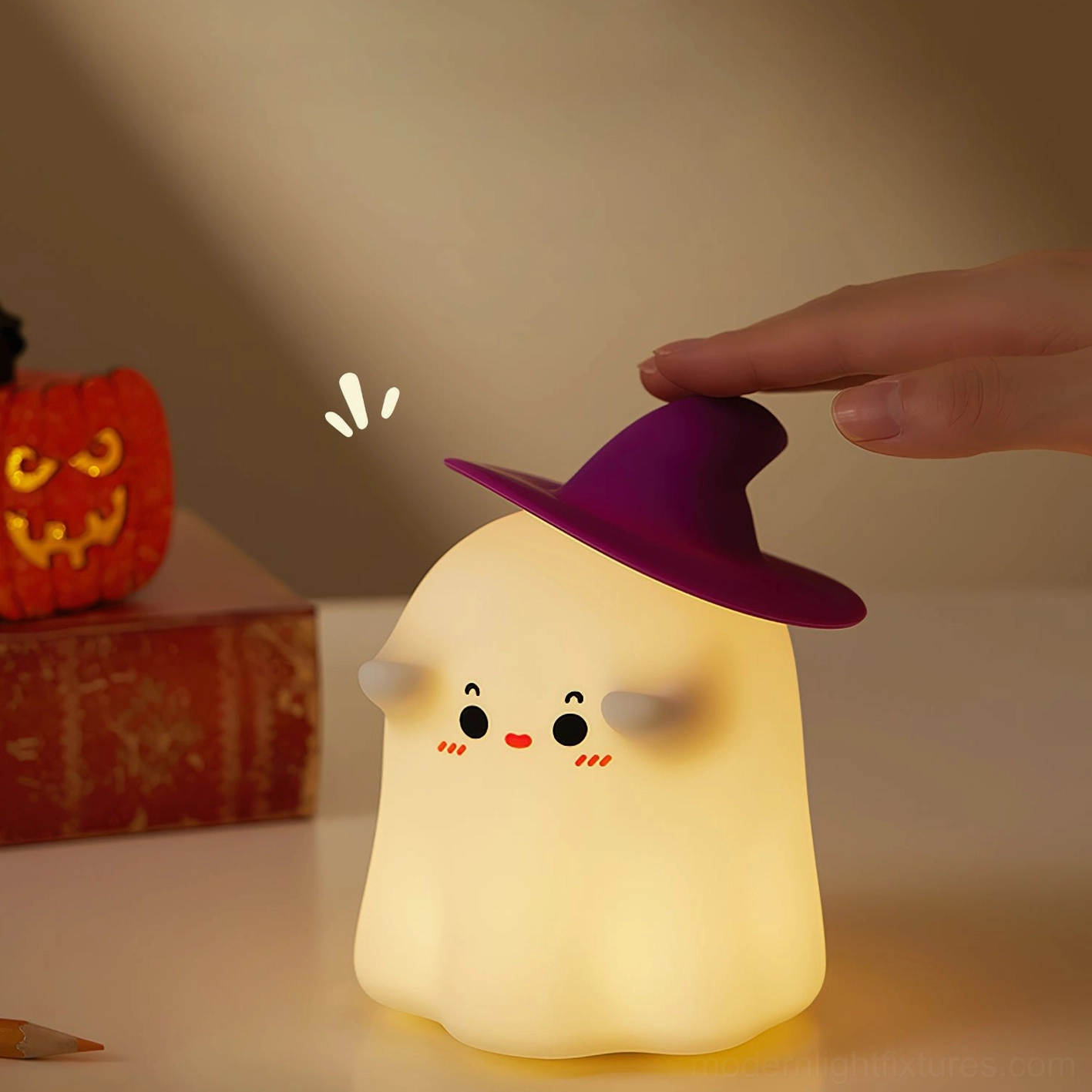Hand tapping enchanted witch ghost night light on Halloween themed tabletop with pumpkin decor