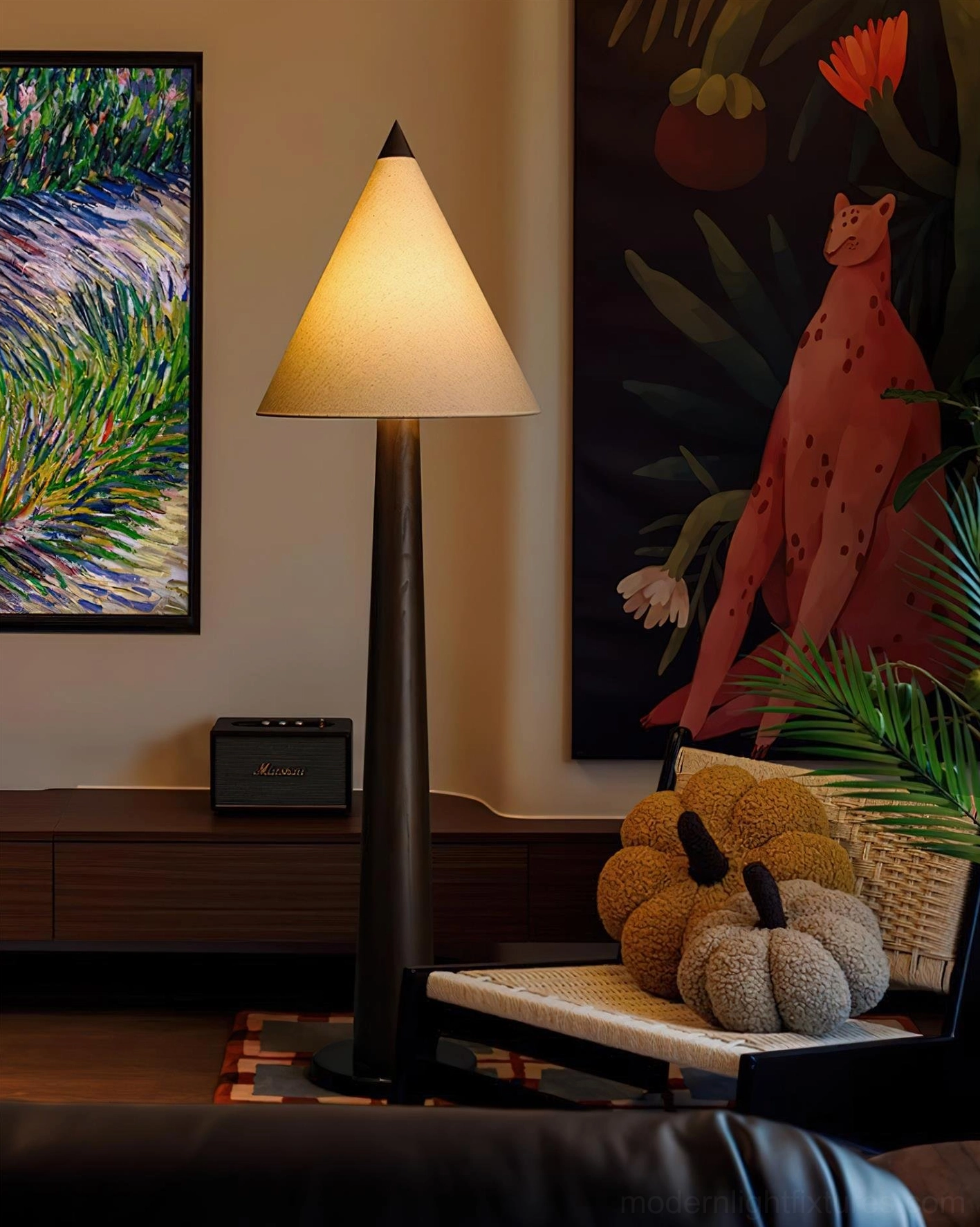 Contemporary tapered floor lamp with black pole and beige cone shade paired with wall art in eclectic living space
