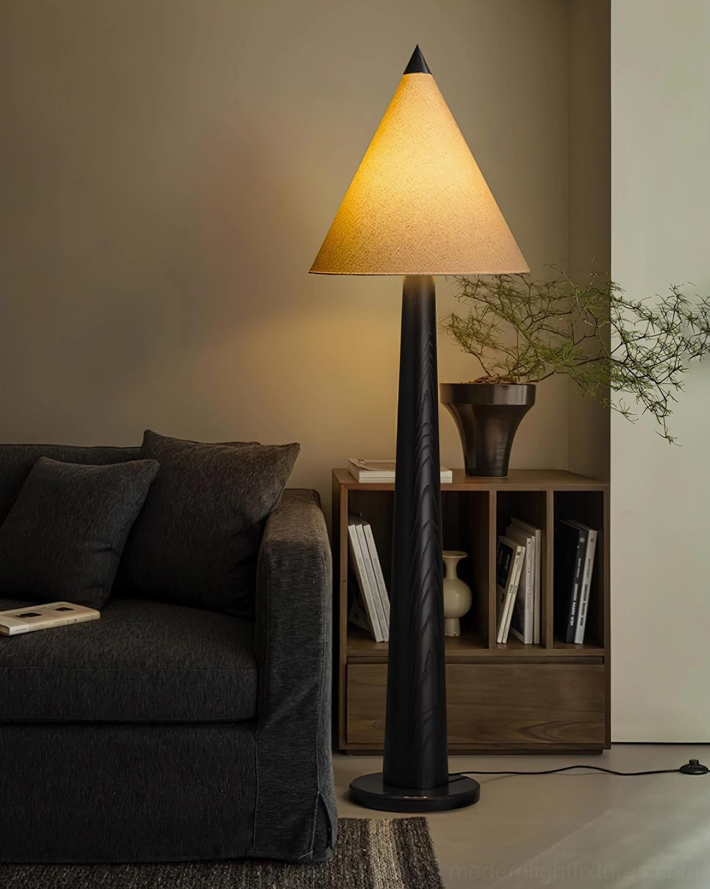Modern compact living room with tapered floor lamp featuring black pole and yellow fabric shade near sofa