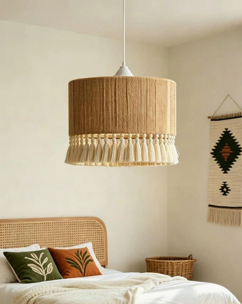 Boho tassel pendant light hanging in warm bedroom with natural beige walls and woven textiles