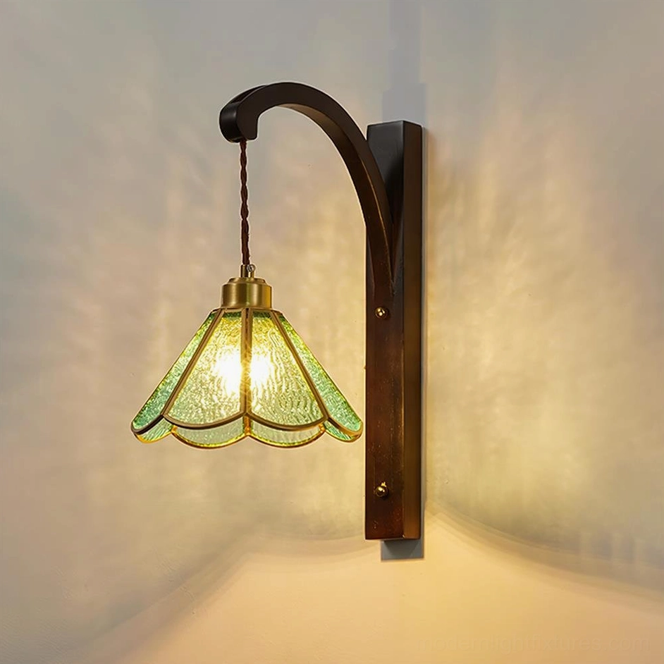 Tavelle petal wall fixture front view with dark bronze bracket and green stained glass shade