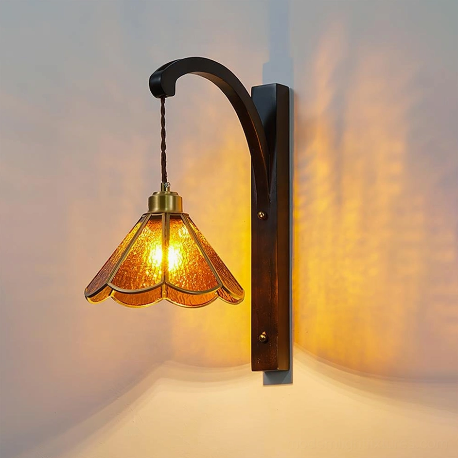Tavelle vintage petal wall lamp low angle front view with warm amber glow on white background