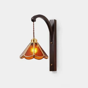 Tavelle vintage petal wall sconce with amber stained glass shade and dark bronze curved bracket, front view on white wall