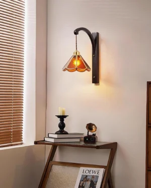 Tavelle wall sconce warm glowing light in bedroom corner with side table, vintage home decor setting