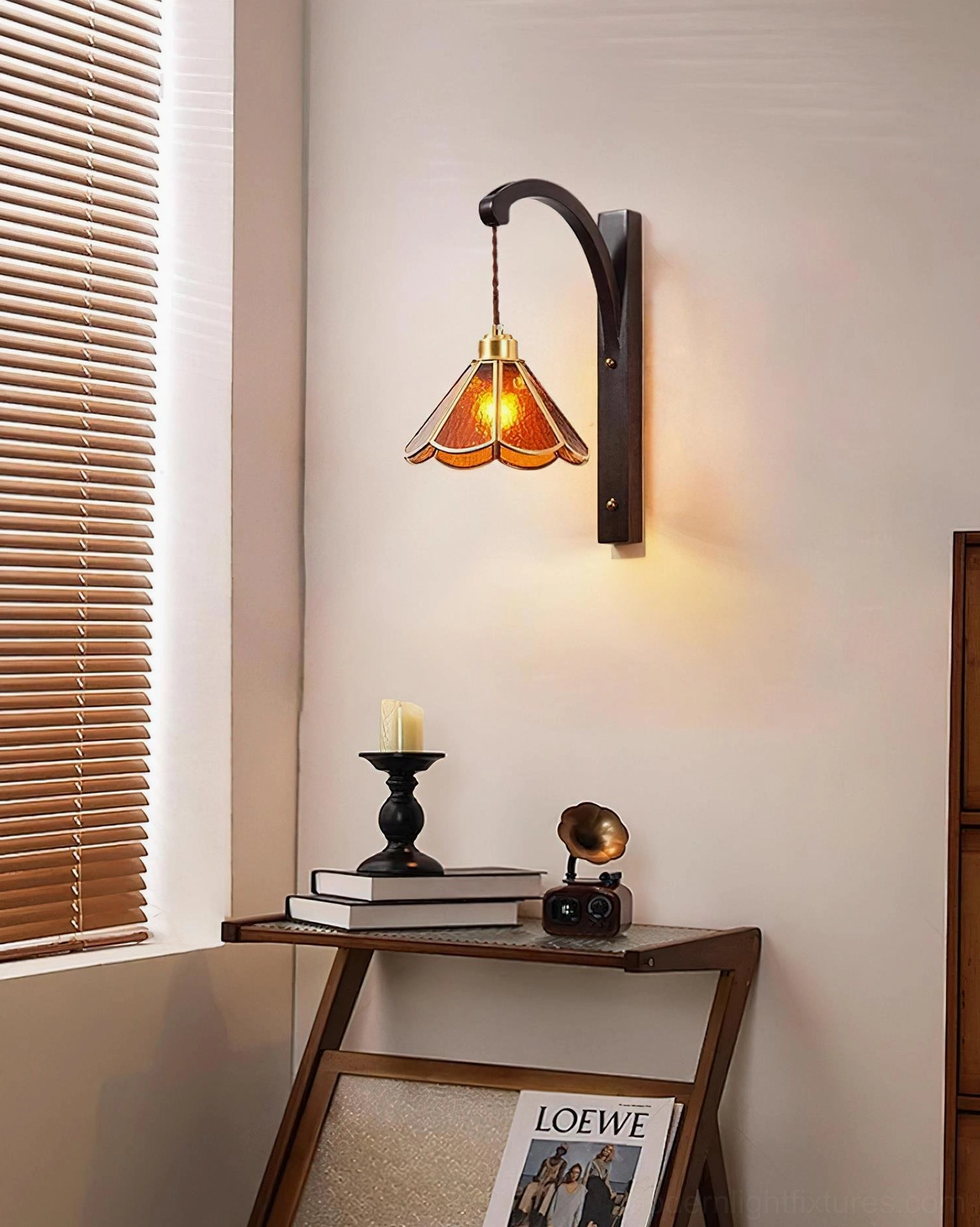 Tavelle wall sconce warm glowing light in bedroom corner with side table, vintage home decor setting
